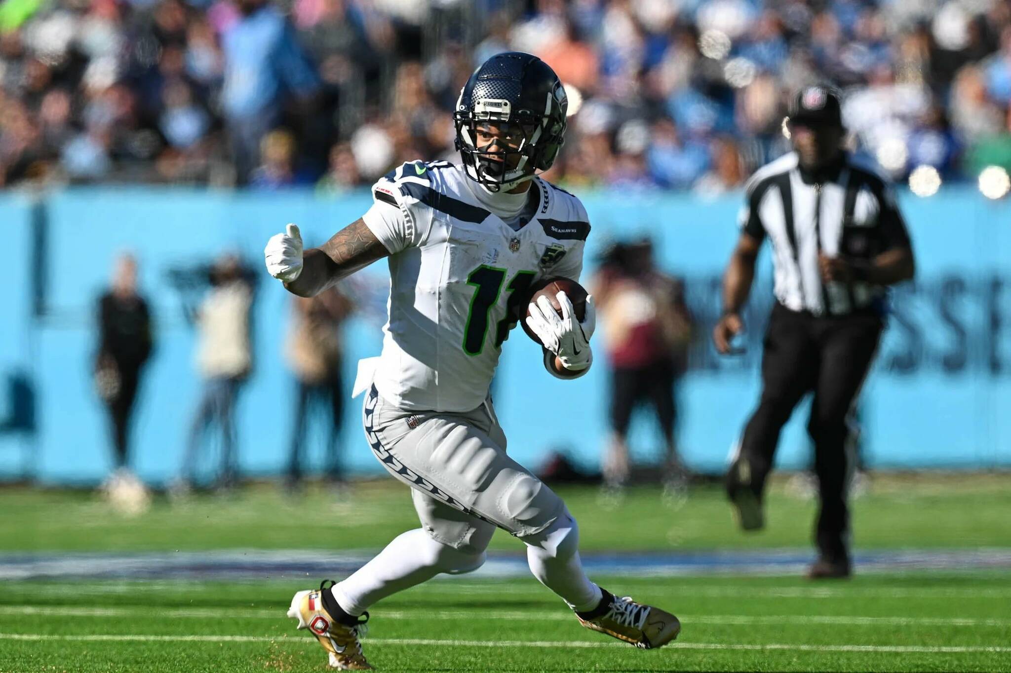 Seahawks receiver Jaxon Smith-Njigba runs with the ball in a game against the Tennessee Titans on Sunday, Nov. 23, 2025. (Photo courtesy of the Seattle Seahawks)
