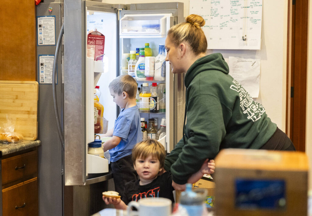 Declan, 5, looks in the fridge during breakfast on Tuesday, Dec. 30, 2025 in Marysville, Washington. (Olivia Vanni / The Herald)
