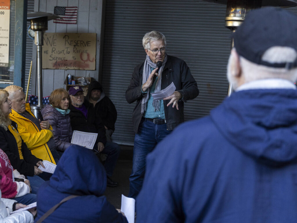Rick Steves speaks to community members gathered at the Jean Kim Foundation Hygiene Center after announcing he purchased the current property so the center will not have to close on Wednesday, Dec. 17, 2025 in Lynnwood, Washington. (Olivia Vanni / The Herald)
