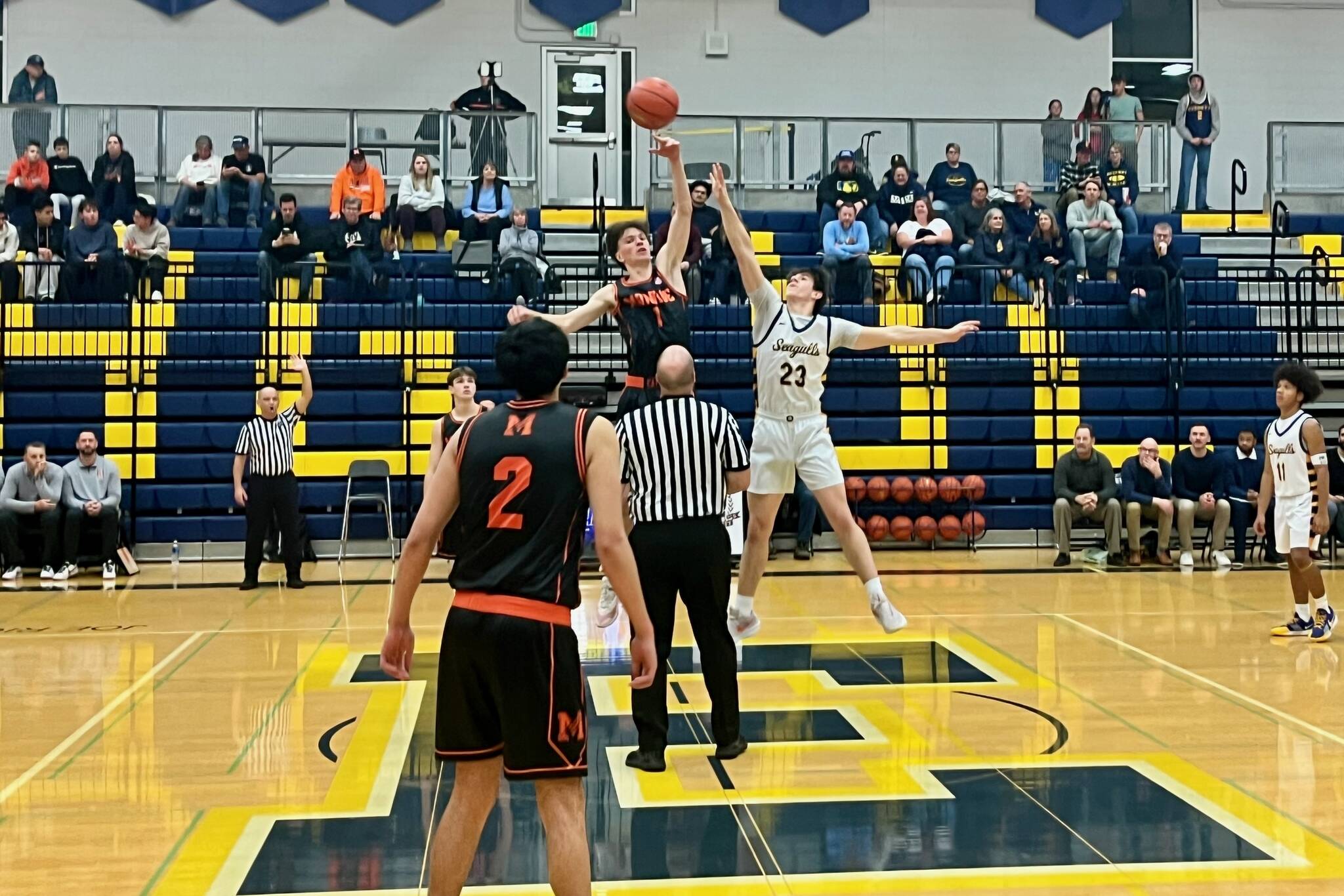 Monroe senior Caleb Campbell (center, in black) wins the opening tip-off in the Bearcats 77-47 win against Everett at Norm Lowery Gymnasium on Jan. 2, 2026. (Joe Pohoryles / The Herald)