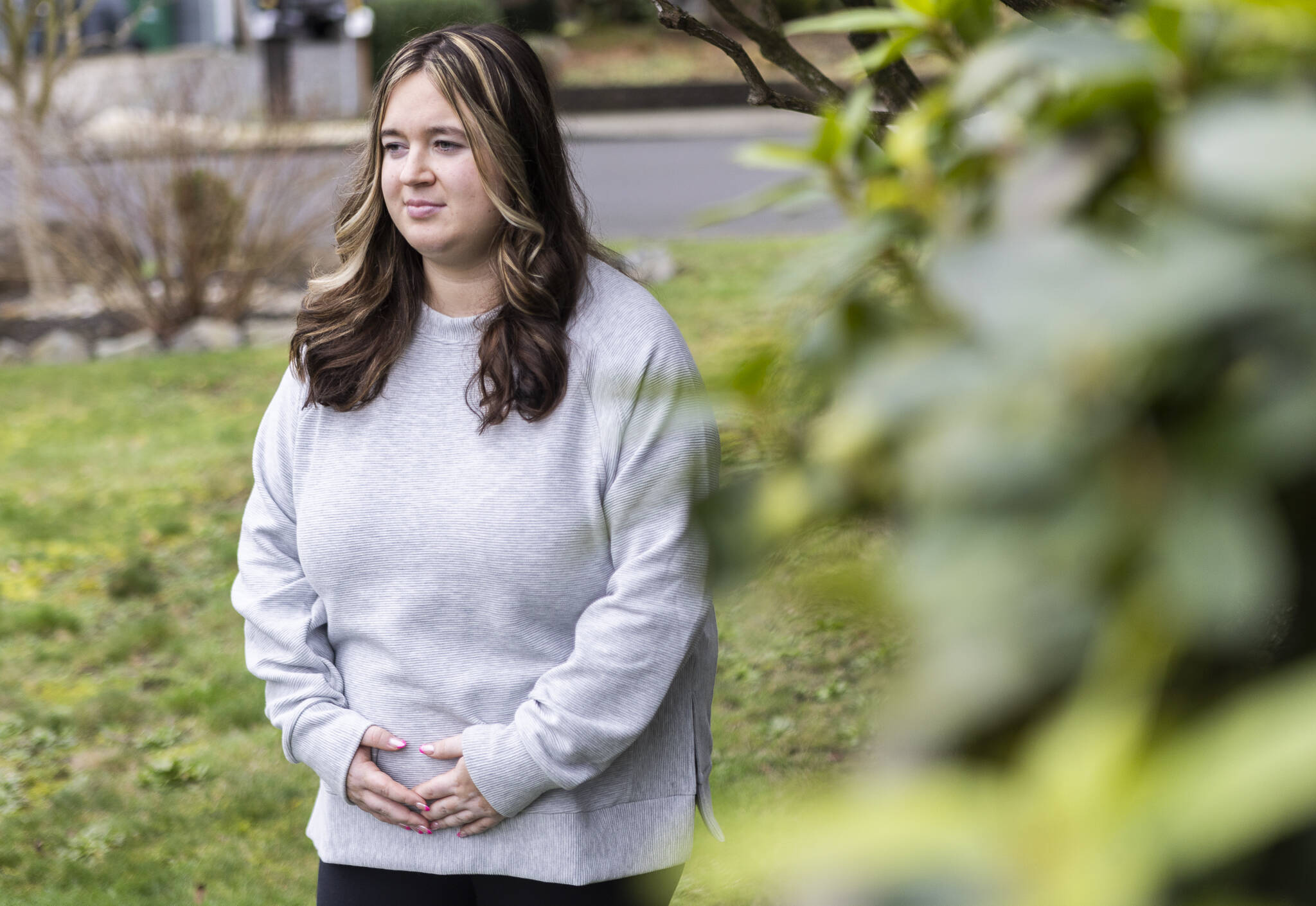 Makena Simonen, 21, outside of her family home on Wednesday, Jan. 14, 2026 in Lynnwood, Washington. (Olivia Vanni / The Herald)