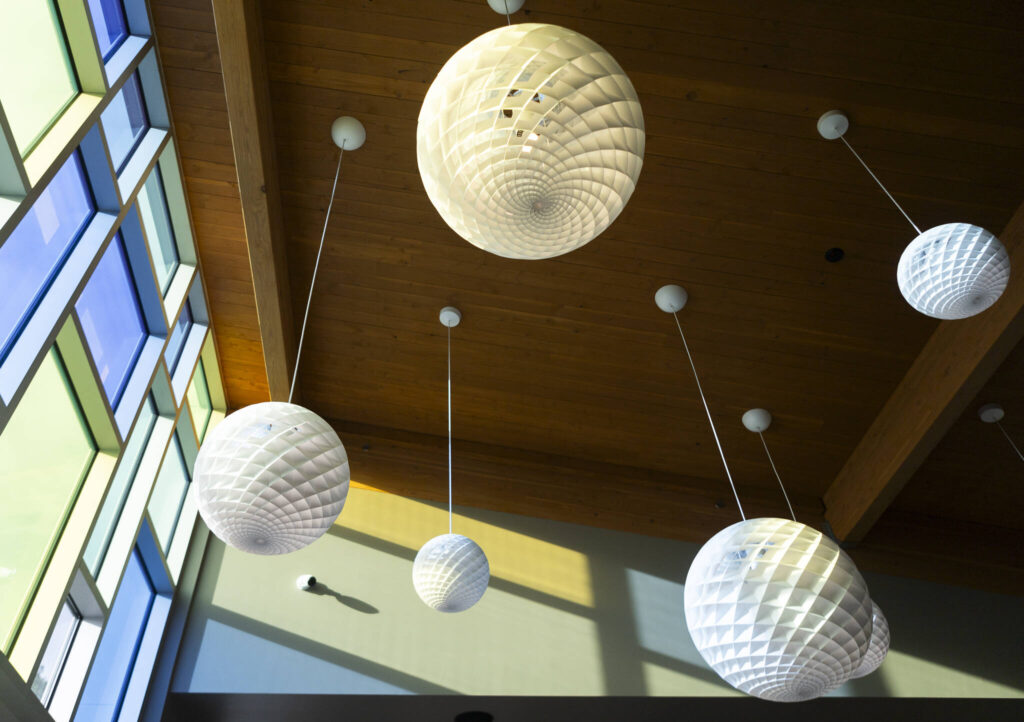 Sun shines through colored glass inside the new Lynnwood Neighborhood Center on Friday, Jan. 9, 2026 in Lynnwood, Washington. (Olivia Vanni / The Herald)
