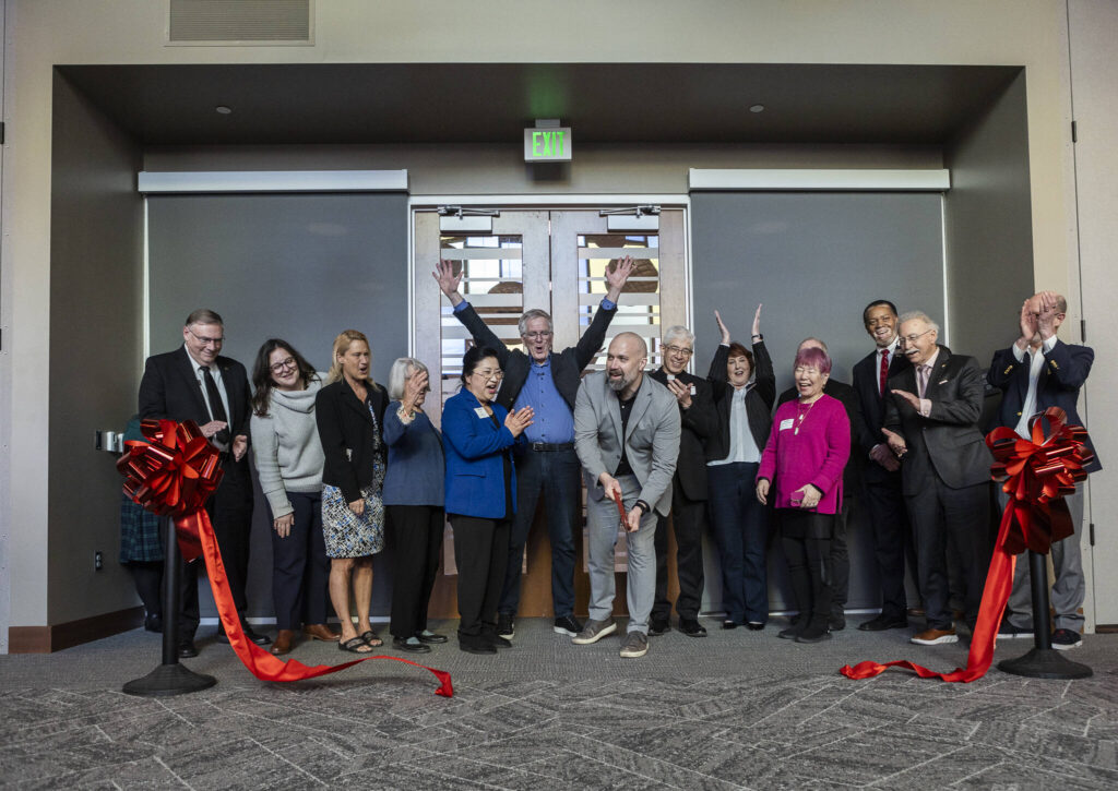 President and CEO of Volunteers of America of Western Washington Brian Smith cut a ribbon during the opening of the Lynnwood Neighborhood Center on Friday, Jan. 9, 2026 in Lynnwood, Washington. (Olivia Vanni / The Herald)
