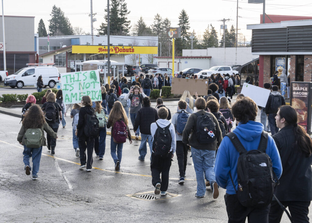Students from Everett High School walk onto Broadway Avenue during a walkout from the high school in protest of ICE on Tuesday, Jan. 13, 2026, in Everett, Washington. (Will Geschke / The Herald)
