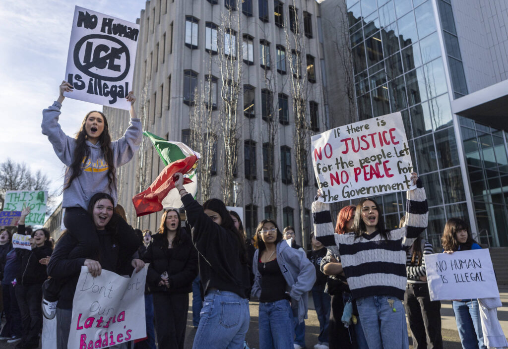 Everett High School students cheer as a car honks during a walkout rally in protest of ICE outside of the Snohomish County Courthouse on Tuesday, Jan. 13, 2026, in Everett, Washington. (Olivia Vanni / The Herald)
