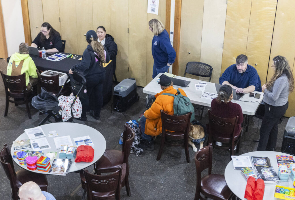 People receive assistance at the Disaster Assistance Center set up at the Volunteers of America Sky Valley Center on Wednesday, Jan. 14, 2026 in Sultan, Washington. (Olivia Vanni / The Herald)
