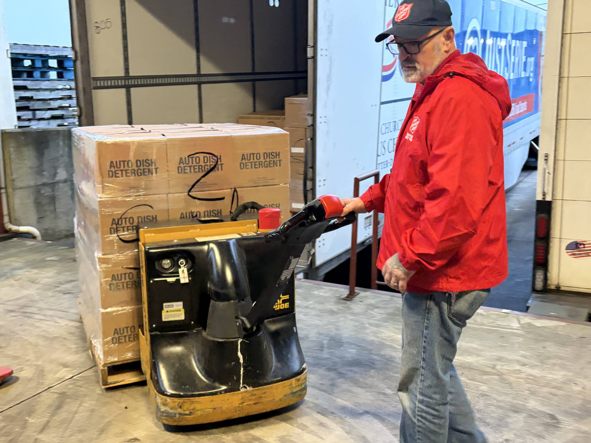 Dan Harding, operations manager with The Salvation Army, removes a pallet of dish soap from a truck carrying 40,000 pounds of food and supplies to The Salvation Army Disaster Distribution Center in Everett, Washington, on Thursday, Jan. 15, 2026. The food and supplies will be distributed to families in need across Snohomish County. (Provided photo)