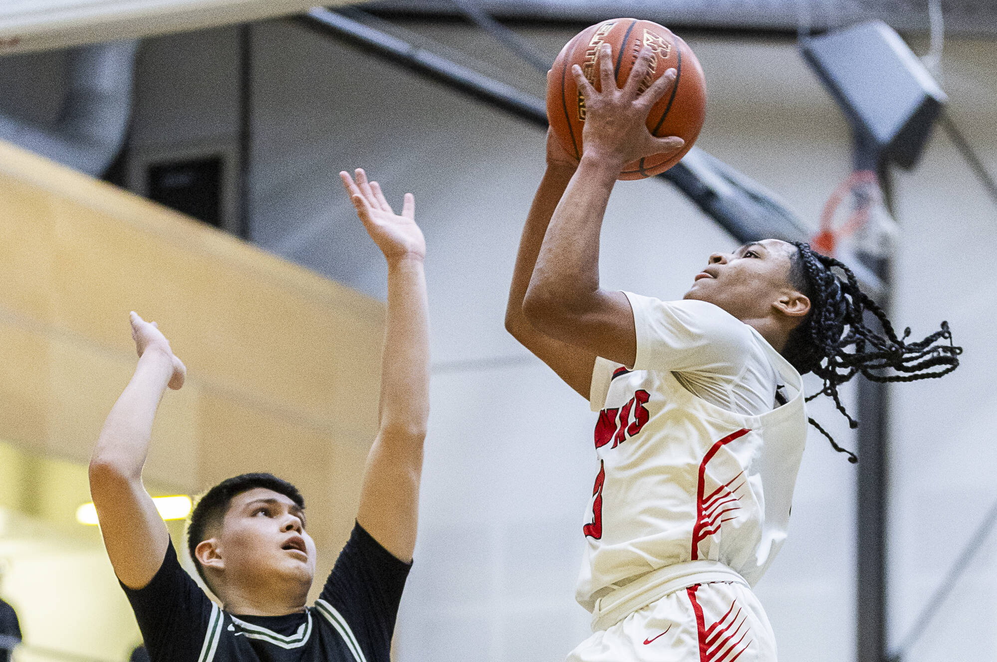 Tulalip Heritage’s JJ Gray makes a layup during the winner-to-state playoff game against Muckleshoot Tribal School on Tuesday, Feb. 18, 2025 in Marysville, Washington. (Olivia Vanni / The Herald)