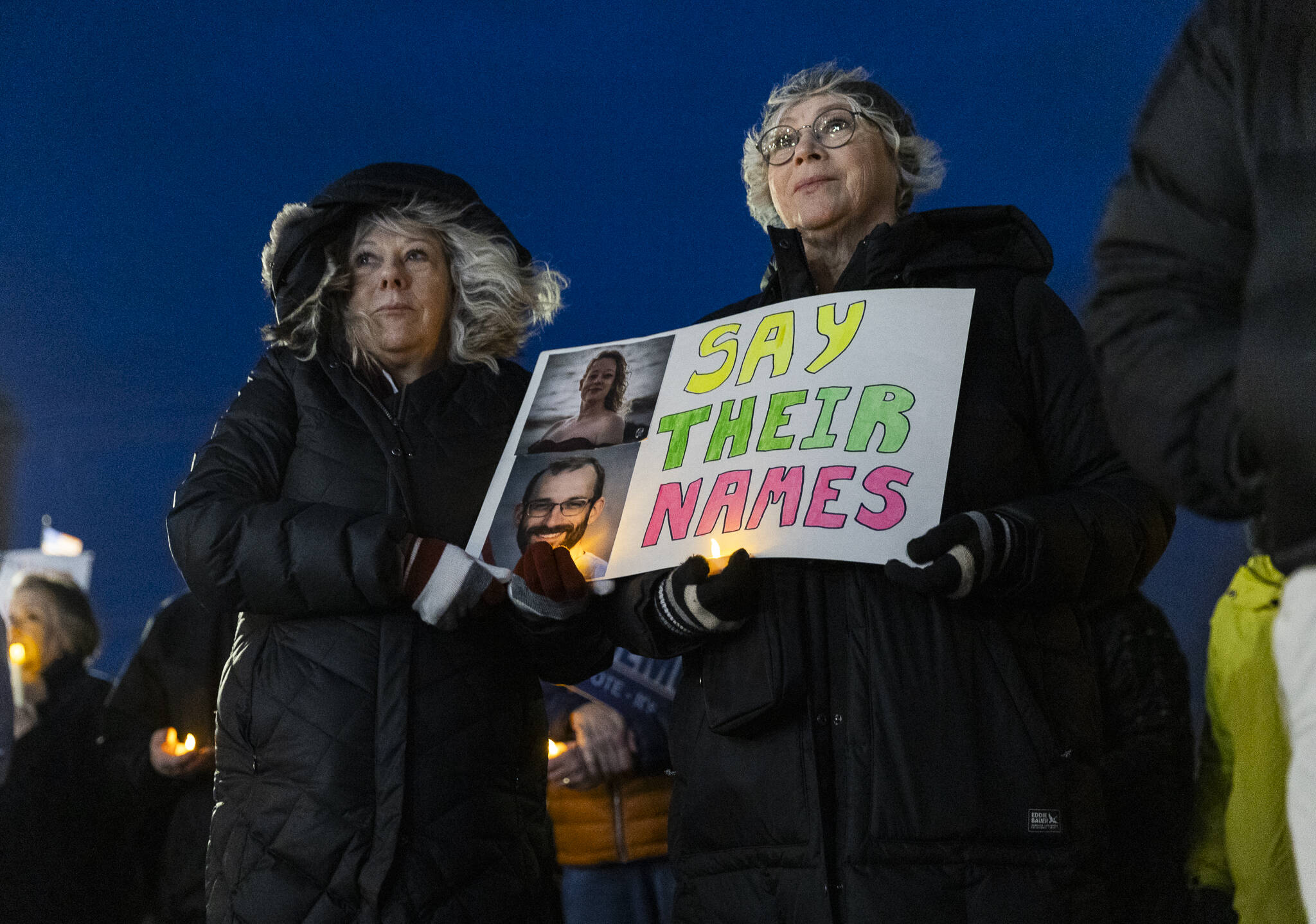 Laurie Hardie and Tammie Enders hold a sign with photographs of Renee Good and Alex Pretti during a vigil held outside of the Snohomish County Courthouse on Tuesday, Jan. 27, 2026, in Everett, Washington. (Olivia Vanni / The Herald)