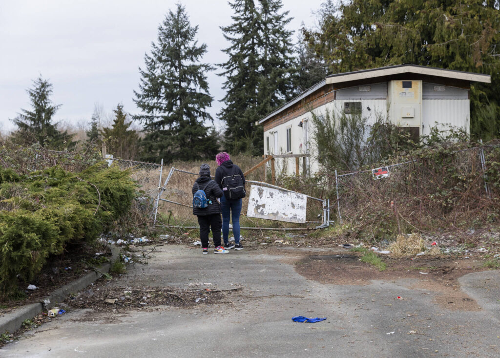 Rachel McGee and Amanda Amoruso check a section of property along Casino Road for people that may be experiencing homelessness on Tuesday, Jan. 27, 2026 in Everett, Washington. (Olivia Vanni / The Herald)
