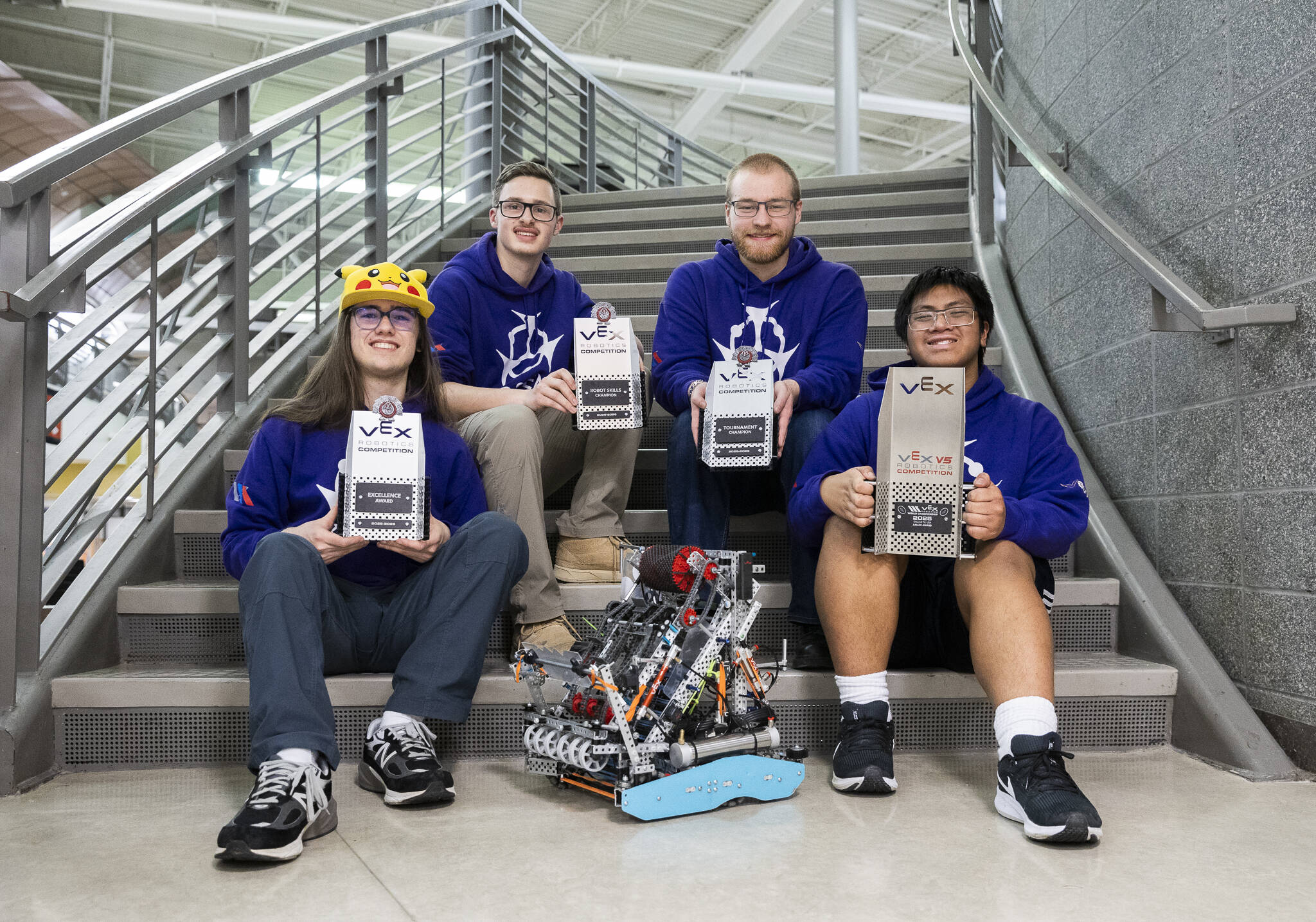 Lake Stevens robotics team 8931R (Arsenic) Colwyn Roberts, Riley Walrod, Corbin Kingston and Chris Rapues with their current robot and awards on Thursday, Jan. 29, 2026 in Lake Stevens, Washington. (Olivia Vanni / The Herald)