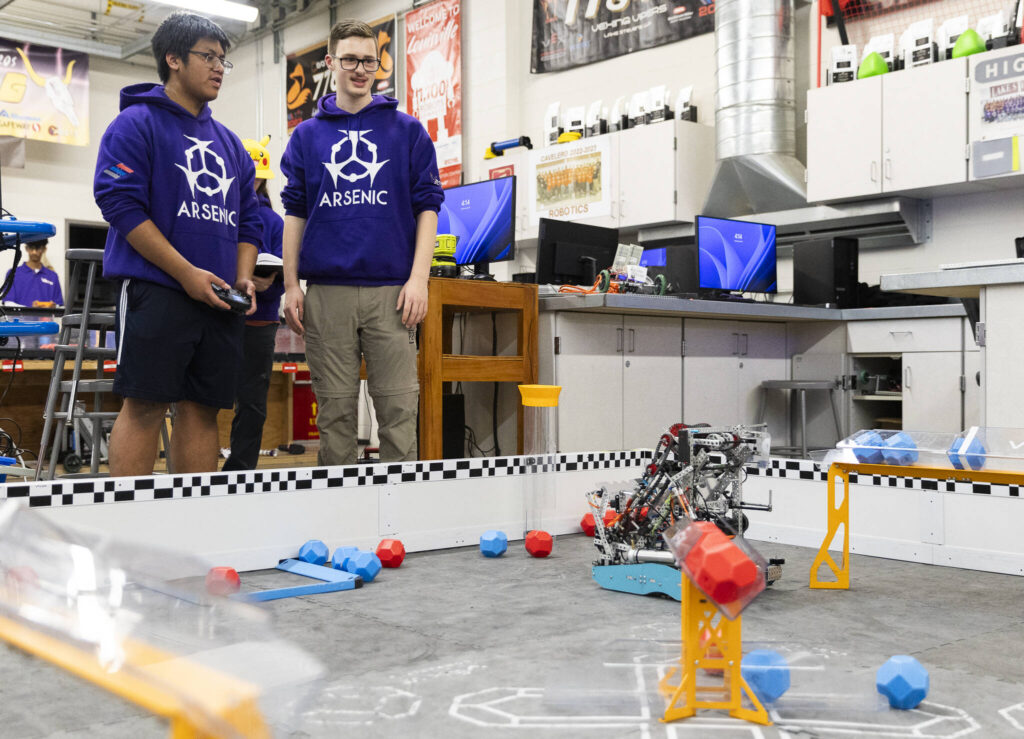 Chris Rapues and Riley Walrod runs their robot through a series of tasks on Thursday, Jan. 29, 2026 in Lake Stevens, Washington. (Olivia Vanni / The Herald)
