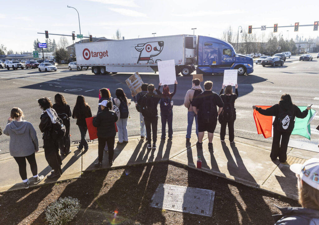 Students holds signs on the corner of 172nd Street Northeast and 27th Avenue Northeast during a student walkout and protest on Thursday, Feb. 5, 2026 in Lakewood, Washington. (Olivia Vanni / The Herald)
