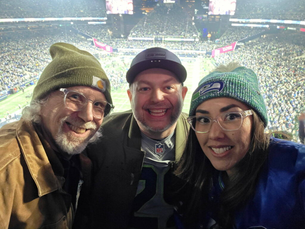 Seth Nilson of Stanwood (center) poses with his wife, Tabitha Nilson (right) and his father, Barry Nilson, at the NFC Championship game between the Seattle Seahawks and Los Angeles Rams at Lumen Field on Sunday, Jan. 25, 2026. (Photo courtesy of Seth Nilson)
