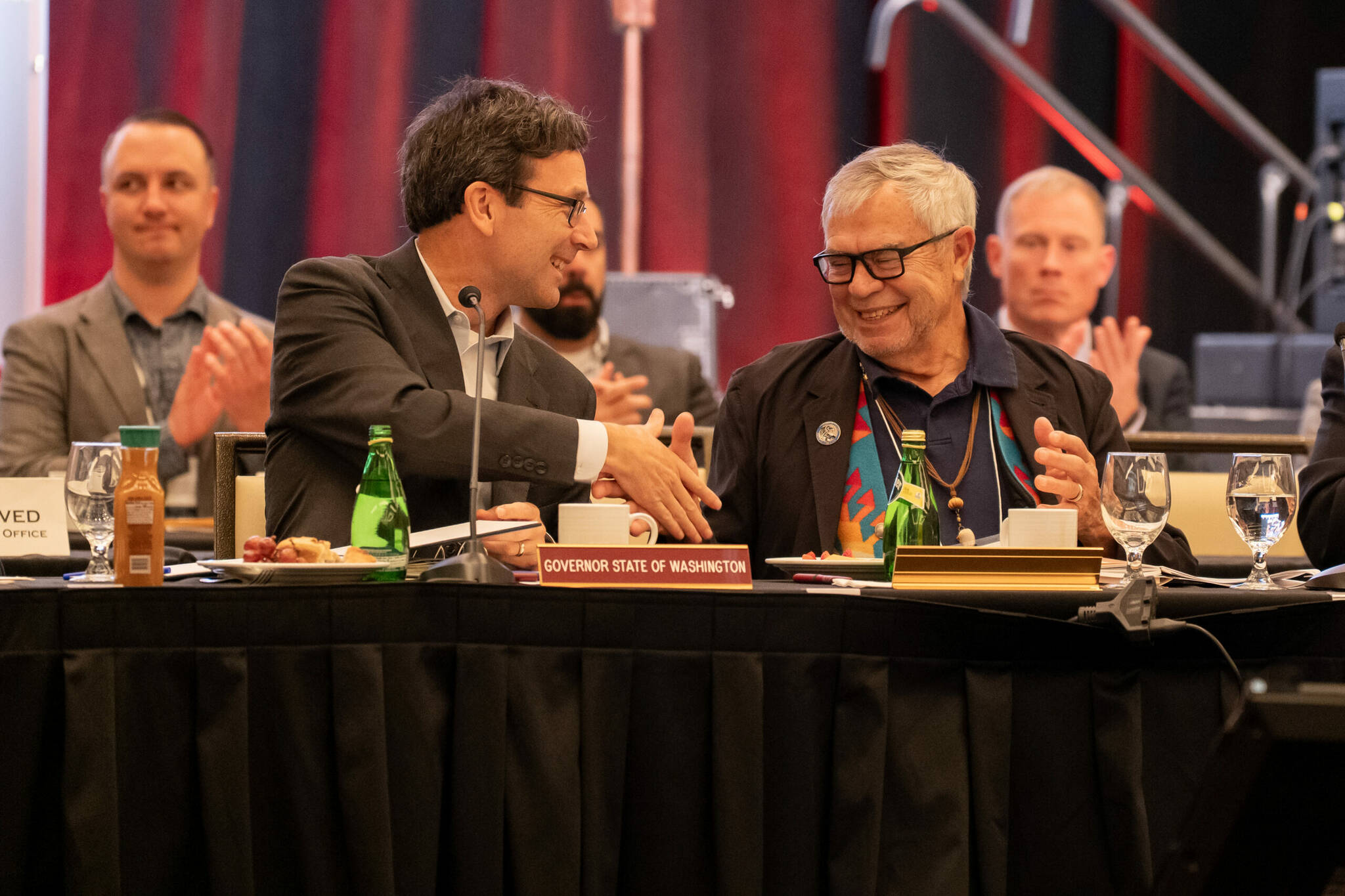 Washington Gov. Bob Ferguson, left, shakes hands with Cowlitz Indian Tribe Chairman Bill Iyall after signing an executive order to improve the states relations with tribal governments on Oct. 22, 2025. (Photo courtesy of Washington governors office)