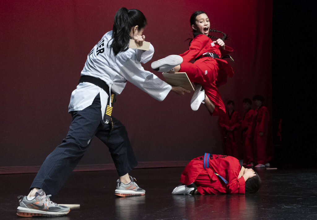 Michaella Mach, 11, breaks a board with a jumping kick during a performance by Taekwondo Way at the City of Mukilteo&rsquo;s Lunar New Year Celebration on Thursday, Feb. 12, 2026 in Mukilteo, Washington. (Olivia Vanni / The Herald)
