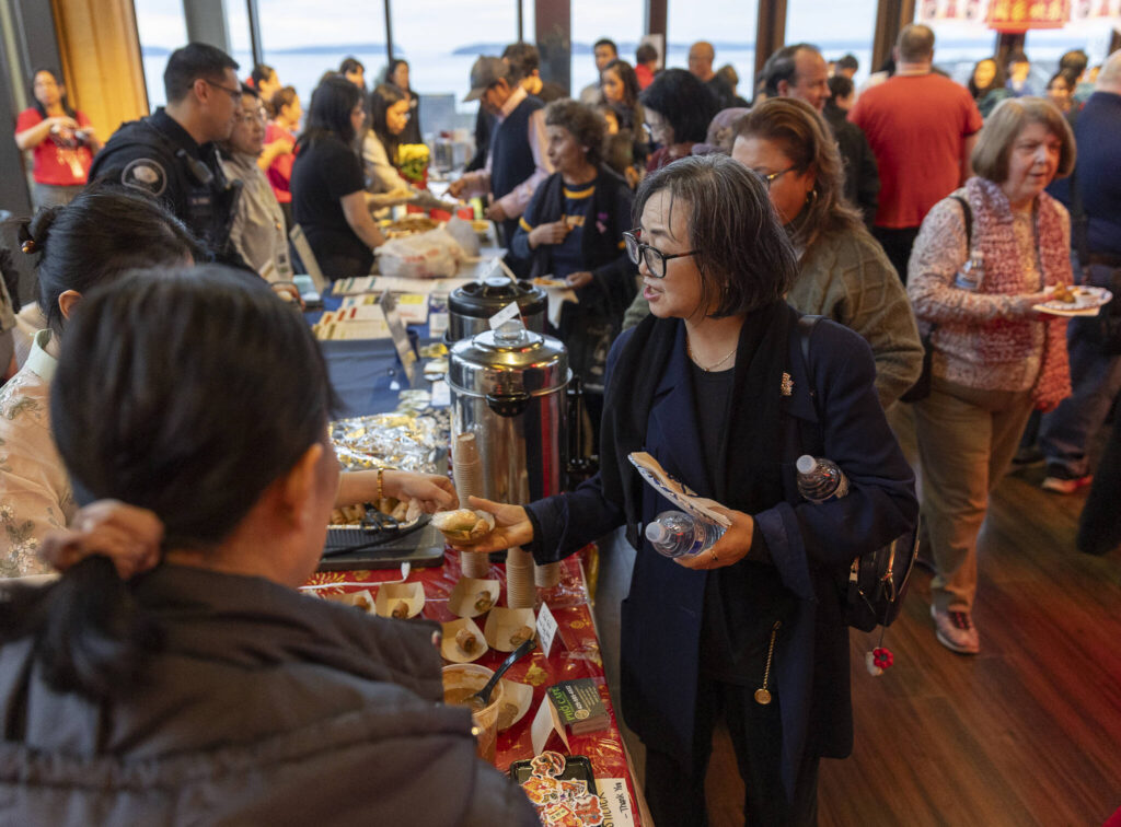People get free food provided by various restaurants and community members during the City of Mukilteo&rsquo;s Lunar New Year Celebration on Thursday, Feb. 12, 2026 in Mukilteo, Washington. (Olivia Vanni / The Herald)
