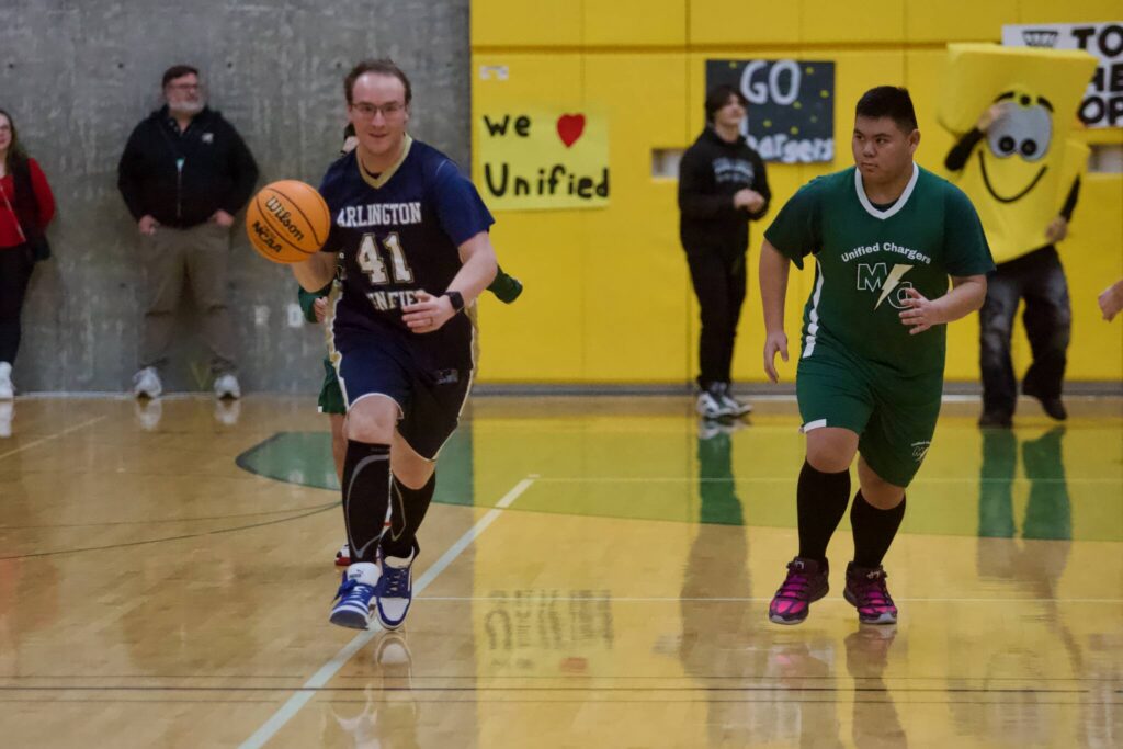 Arlington&rsquo;s Devin Blumm (left) dribbles the ball up the court during the Eagles unified basketball game at Marysville Getchell High School on Feb. 9, 2026. (Joe Pohoryles/The Herald)
