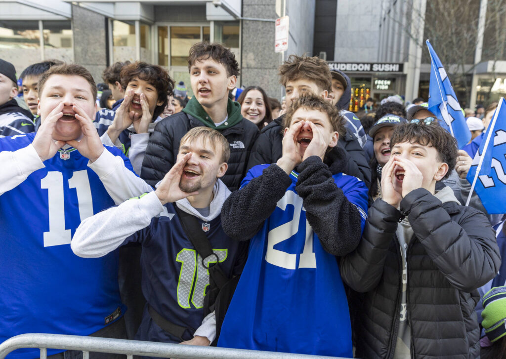 Simon Kurishko, Stas Demchuk, Artem Orlov, Max Demchuk, Jayden Nguyen, Alex Gubenya and Mark Shipachev, students from Mariner, Cascade and Kamiak high schools cheer during the Seahawks World Champions Parade on Wednesday, Feb. 11, 2026 in Seattle, Washington. (Olivia Vanni / The Herald)
