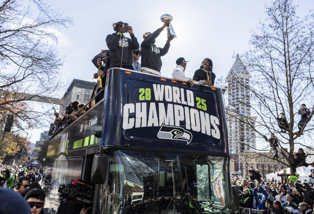 Seattle Seahawks&rsquo; Kenneth Walker III holds the Lombardi Trophy as their bus makes it way along 4th Avenue during the Seahawks World Champions Parade on Wednesday, Feb. 11, 2026, in Seattle, Washington. (Olivia Vanni / The Herald)
