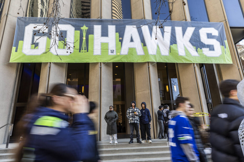 People walk along 4th Avenue before the start of the Seahawks World Champions Parade on Wednesday, Feb. 11, 2026, in Seattle, Washington. (Olivia Vanni / The Herald)
