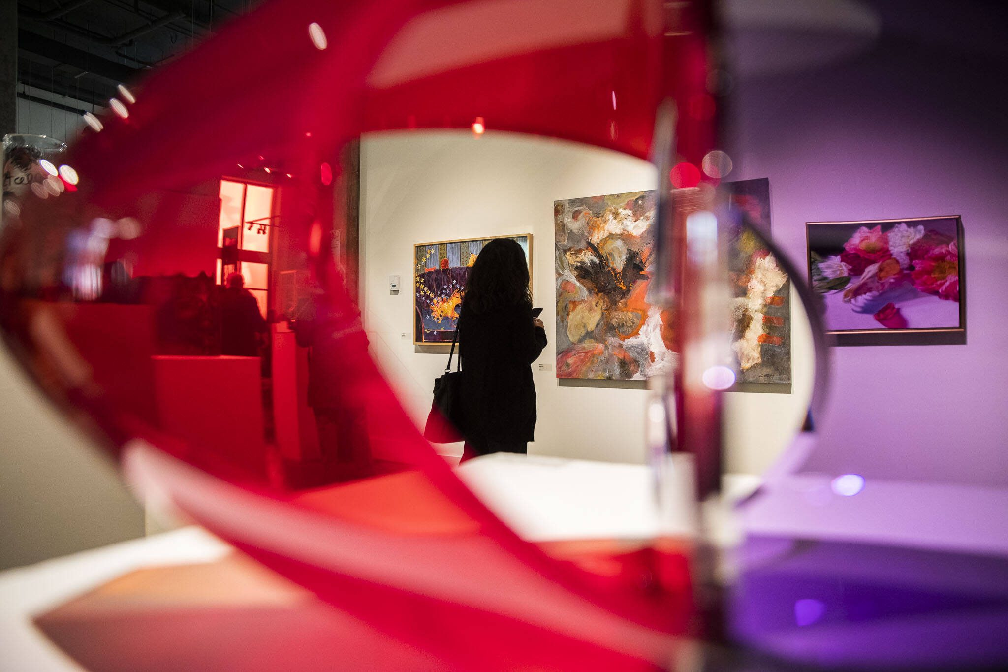 A person pauses to look at an art piece during the Schack Art Center’s 50th anniversary celebration on Thursday, Oct. 10, 2024 in Everett, Washington. (Olivia Vanni / The Herald)