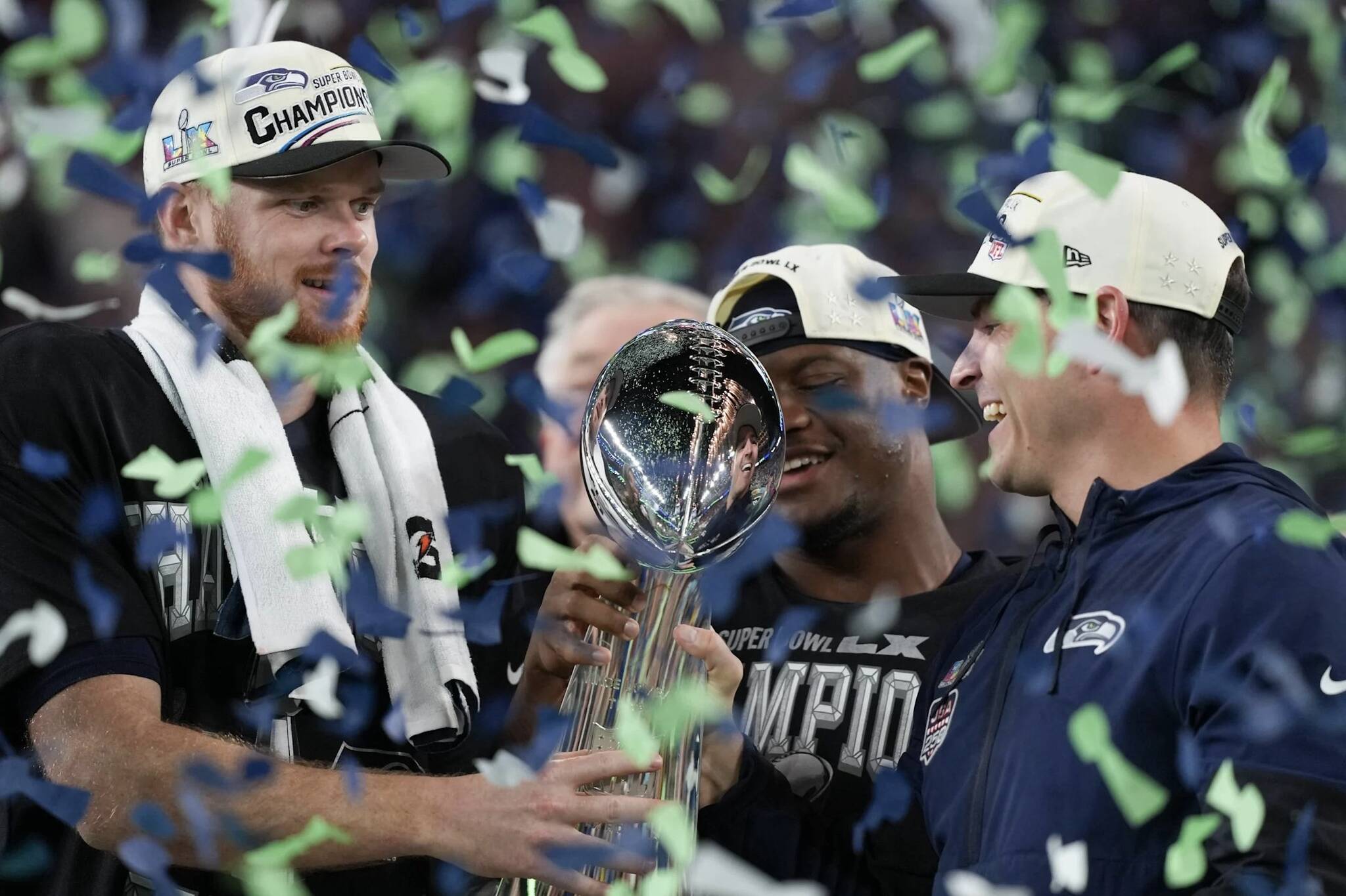 Seahawks quarterback Sam Darnold (left), Super Bowl MVP Kenneth Walker III (center) and head coach Mike Macdonald celebrate with the Lombardi Trophy after defeating the New England Patriots 29-13 at Super Bowl LX at Levis Stadium in Santa Clara, California on Sunday. (Photo courtesy of the Seattle Seahawks)