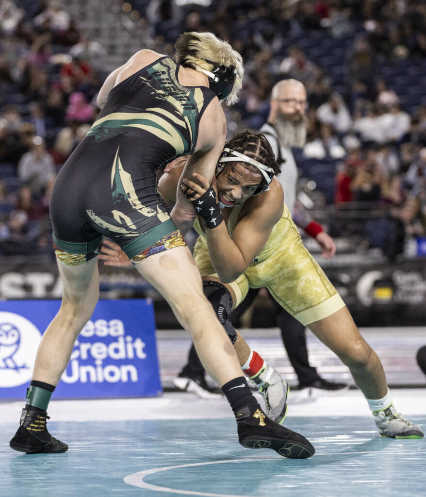 Arlington&rsquo;s Tre Haines attempts a takedown during the 4A boys 165-pound championship match at the Mat Classic on Friday, Feb. 20, 2026 in Tacoma, Washington. (Olivia Vanni / The Herald)
