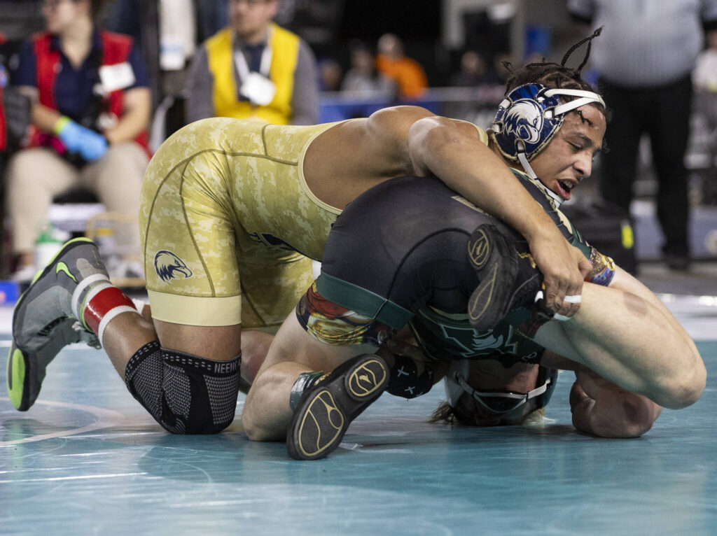 Arlington&rsquo;s Tre Haines gains control of his opponents leg during the 4A boys 165-pound championship match at the Mat Classic on Friday, Feb. 20, 2026 in Tacoma, Washington. (Olivia Vanni / The Herald)
