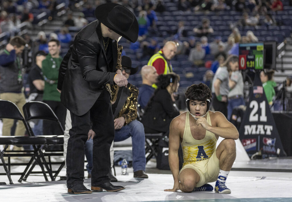 Arlington&rsquo;s Dayton Fitzgibbon listens to his coach during the 4A boys 144-pound championship match at the Mat Classic on Friday, Feb. 20, 2026 in Tacoma, Washington. (Olivia Vanni / The Herald)
