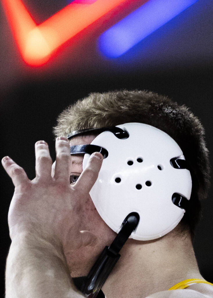 Everett&rsquo;s Alex Buiukli adjusts his ear protection during the 3A boys 165-pound semifinal match at the Mat Classic on Friday, Feb. 20, 2026 in Tacoma, Washington. (Olivia Vanni / The Herald)
