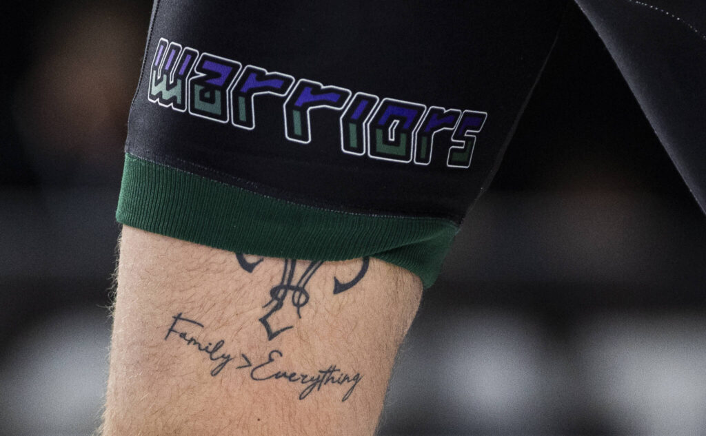 A tattoo that says &ldquo;family > everything&rdquo; is visible on Edmonds-Woodway&rsquo;s Carmelo Larocca while he wrestles in the 3A boys 190-pound championship match at the Mat Classic on Friday, Feb. 20, 2026 in Tacoma, Washington. (Olivia Vanni / The Herald)
