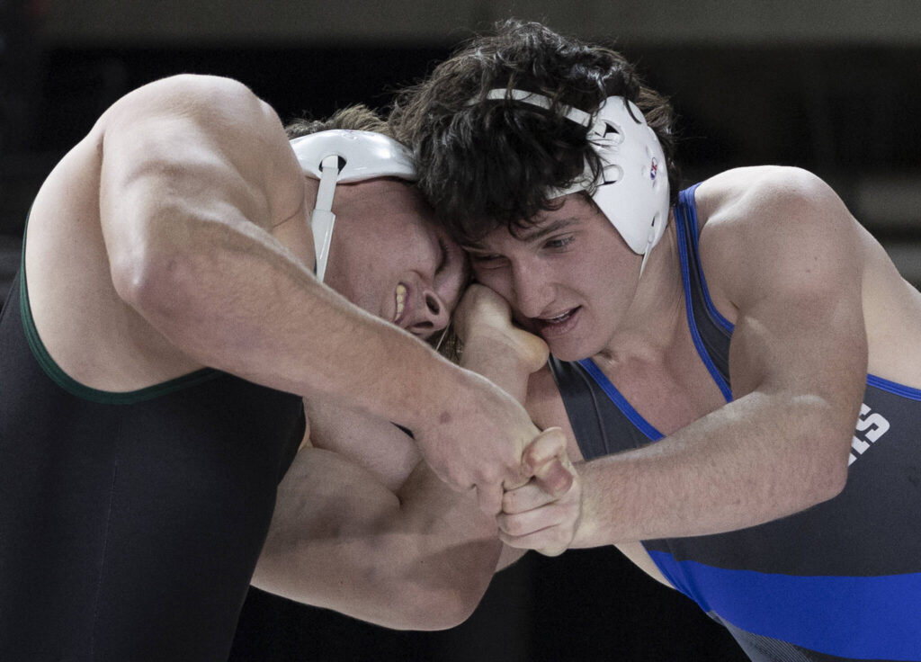 Edmonds-Woodway&rsquo;s Carmelo Larocca grabs the face of Shorewood&rsquo;s Lukas Probizanski during the 3A boys 190-pound championship match at the Mat Classic on Friday, Feb. 20, 2026 in Tacoma, Washington. (Olivia Vanni / The Herald)
