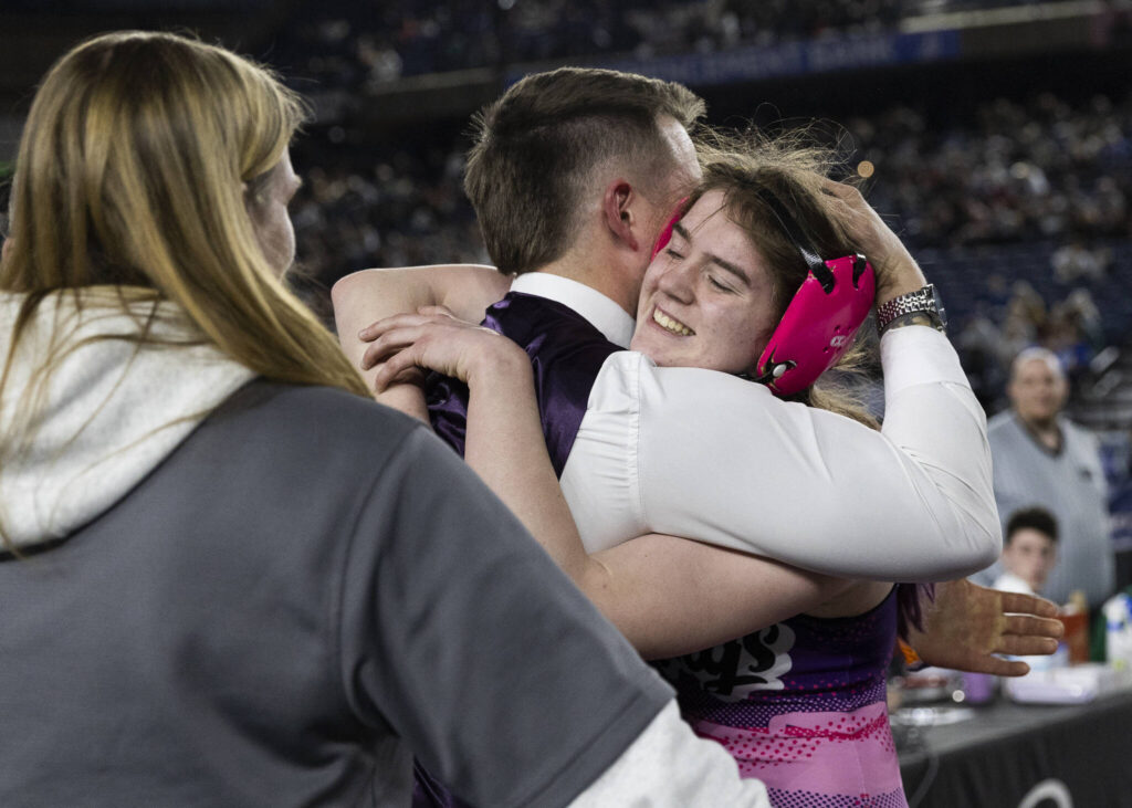 Lake Stevens&rsquo; Kylee Wicklund hugs coach Krys DuPree after winning the 4A girls 145-pound championship match at the Mat Classic on Friday, Feb. 20, 2026 in Tacoma, Washington. (Olivia Vanni / The Herald)
