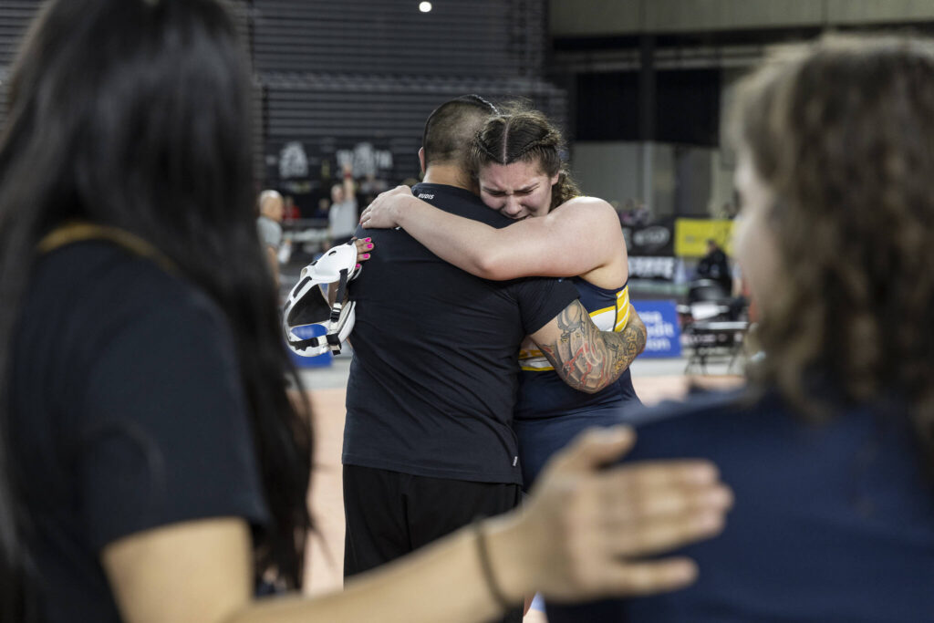 Everett&rsquo;s Mia Cienega hugs her coach after winning the 3A girls 235-pound championship match at the Mat Classic on Friday, Feb. 20, 2026 in Tacoma, Washington. (Olivia Vanni / The Herald)
