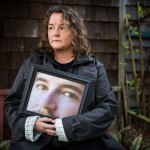 Ian Terry / The HeraldTiffany Ferrians holds a portrait of her son Keaton Farris at her home on Lopez Island on Thursday, Nov. 5, 2015. Farris, who was in the midst of a mental health crisis when he was incarcerated, died of dehydration and malnutrition at the Island County Jail in Coupeville in April.Photo taken on 11052015