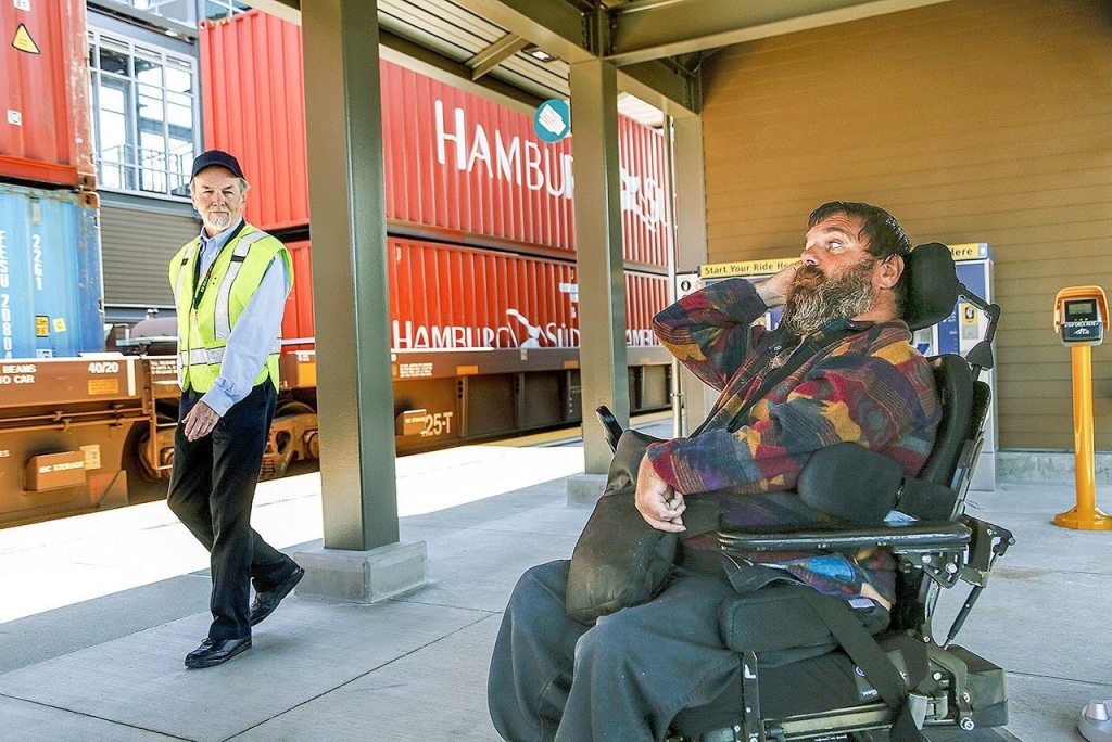 Kent McDaniel, of Everett, sits in a passenger holding area on the west side of the Mukilteo Station. A station agent who, among other things, can tell passengers which side of the tracks the Sounder will stop at, so they can be at the right platform in time to get on. McDaniel has missed quite a few trains previously due to not knowing which side they would stop, and not being able to cross over quickly enough to catch them before they pulled out. (Dan Bates / The Herald)