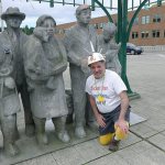 The Fremont Tour creator Mark Ukelson with &ldquo;Waiting for the Interurban,&rdquo; a cast aluminum sculpture of people and a dog waiting for a bus that never comes. The sculpture is among the quirky artworks on the tour.