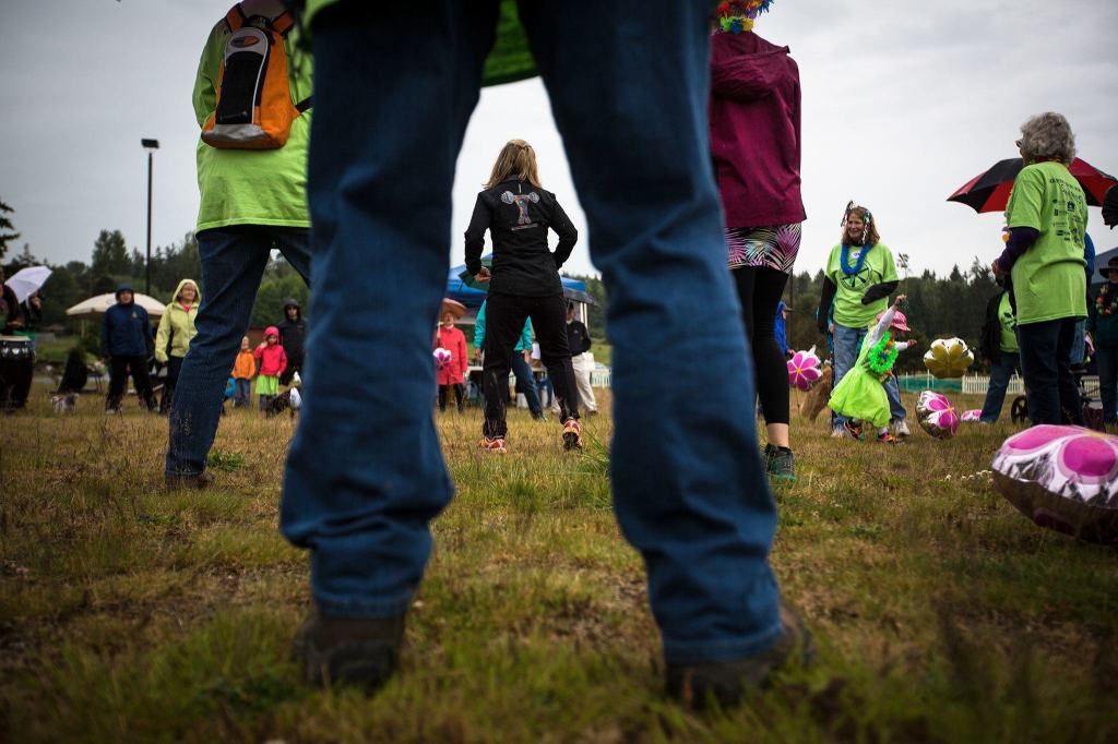 Patricia Maddux, owner of Equipped4Life Fitness, leads the warmup before the Meals on Wheels Walkathon and fundraiser on May 21 on Whidbey Island. (Daniella Beccaria / For the Herald)