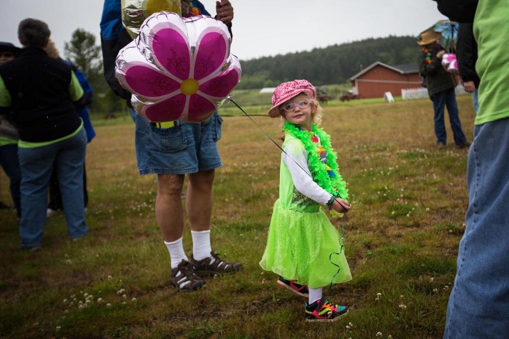Bailee Furness, 3, admires her pink balloon during the Meals on Wheels Walkathon and fundraiser on May 21 on Whidbey Island. (Daniella Beccaria / For the Herald)