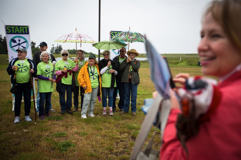 Debbie Metz, nutrition director for Senior Services of Island County, takes a photo of the Oak Harbor Senior Center participants during the Meals on Wheels Walkathon and fundraiser on May 21 on Whidbey Island. (Daniella Beccaria / For the Herald)