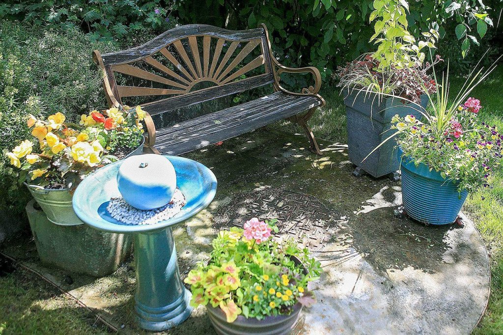 The garden of Michael and Gary Crawford includes a patio made from a sewer access pad, one of many features of the Mill Creek garden. (Kevin Clark / The Herald)