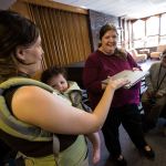 Daniella Beccaria / For the Herald Pastor Rebecca Sumner blesses Grace Hutson-Miller&rsquo;s laptop at &ldquo;blessing of the electronics&rdquo; during a church service for Our Common Table on Sunday, Jun. 26, 2016 at the First Presbyterian Church in Everett. Sumner organized the event to help members focus on how electronics influence their lives. &ldquo;Everything we have in our life can be used for good and can be used for harm,&rdquo; she said. &ldquo;It is important to remember that what we have is blessed.&rdquo;