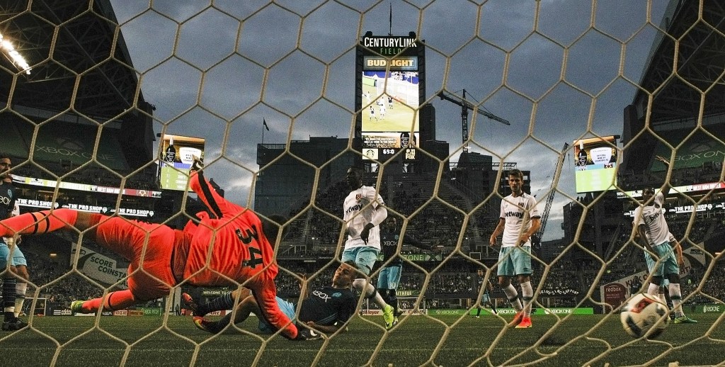 A shot from Sounders forward Jordan Morris (center) rolls past West Ham United goalkeeper Raphael Spiegel for a goal in the second half of an international friendly match at CenturyLink Field in Seattle on Tuesday. (Ian Terry / The Herald)