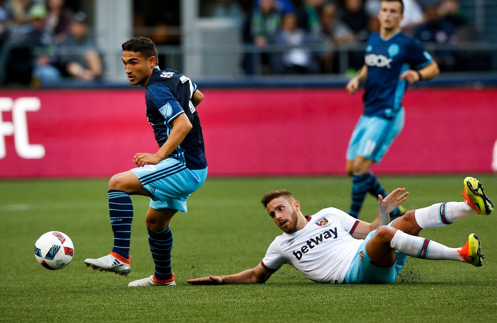Sounders midfielder Cristian Roldan (left) gains control of the ball after a tackle on West Ham United&rsquo;s Diego Poyet during an international friendly Tuesday at CenturyLink Field in Seattle. (Ian Terry / The Herald)