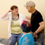 Kathleen Scott laughs and holds up a wind chime as if it were an earring as Ron LaCount and Gwyneth Ginther look on during an art therapy support group at Providence Regional Cancer Partnership. (Andy Bronson / The Herald)