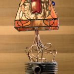 One of Ron LaCount&rsquo;s stained-glass lamp combines his love of motorcycles and glass. (Andy Bronson / The Herald)