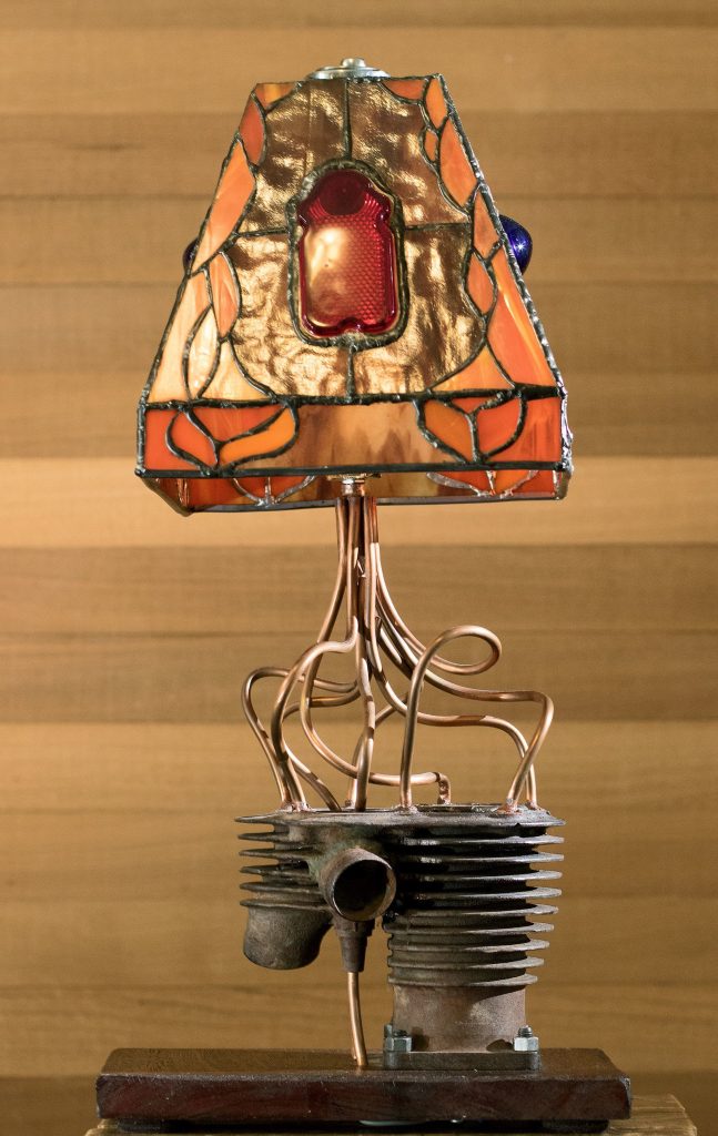 One of Ron LaCount&rsquo;s stained-glass lamp combines his love of motorcycles and glass. (Andy Bronson / The Herald)
