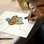 Ron LaCount draws out a new stain glass using agates during an art therapy support group at Providence Regional Cancer Partnership. (Andy Bronson / The Herald)