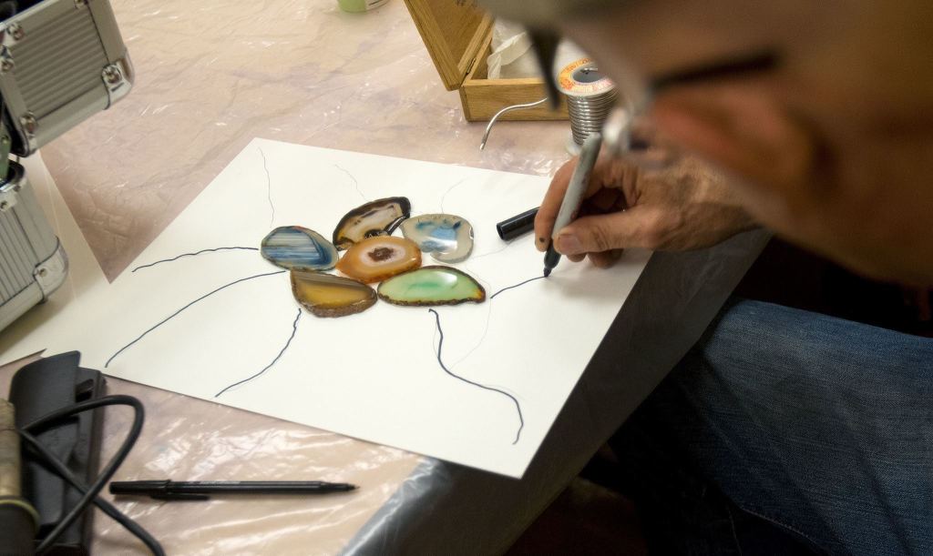 Ron LaCount draws out a new stain glass using agates during an art therapy support group at Providence Regional Cancer Partnership. (Andy Bronson / The Herald)